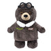 A brown teddy bear wears Plushy's Closet Aviator Costume—an eco-friendly plush outfit with PILOT and wing patches, white collar, and black goggles—perfect for creative play.
