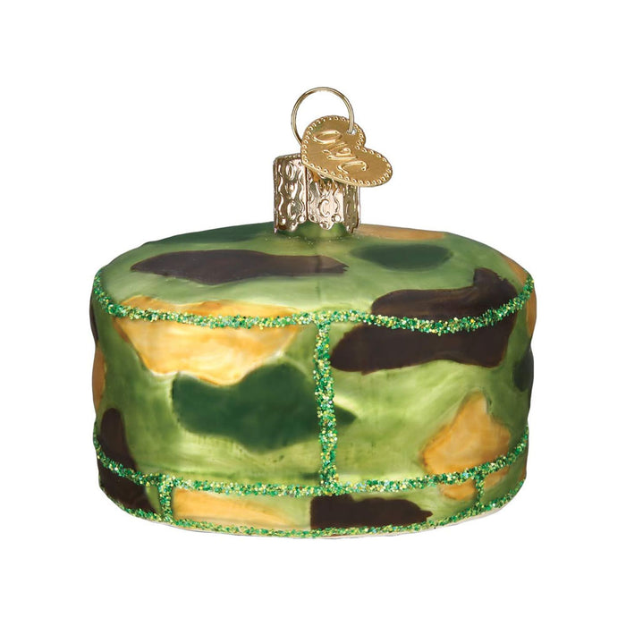 The Army Cap Ornament is a round decoration styled like a cake, featuring green, brown, and yellow camouflage, a gold cap with hanging loop, and green glitter trim for a festive military accent.