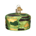 The Army Cap Ornament is a round decoration styled like a cake, featuring green, brown, and yellow camouflage, a gold cap with hanging loop, and green glitter trim for a festive military accent.