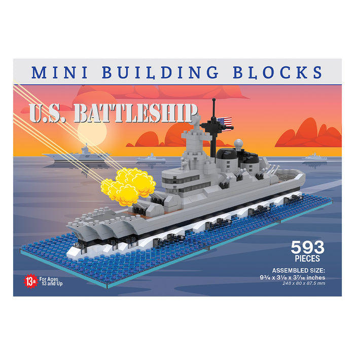 Box for the U.S. Battleship Mini Blocks set, featuring artwork of a gray battleship model at sea amid explosions and smoke under a sunset sky. Inspired by American maritime heritage and naval engineering, the set includes 593 pieces and is recommended for ages 13 and up.