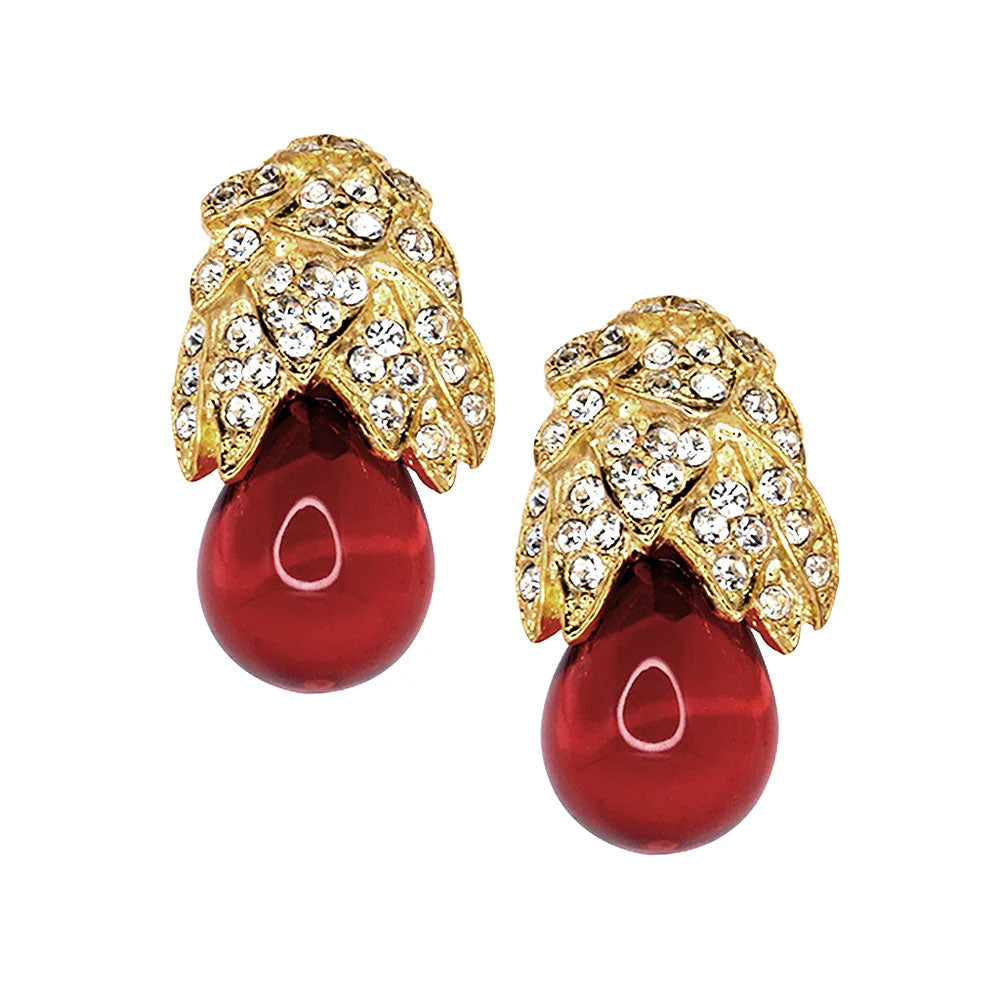 Introducing the Feathered Ruby Clip-On Earrings, featuring red teardrop stones and vintage gold-plated caps adorned with clear rhinestones in a delicate leaf motif.