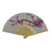 The Cherry Blossom Fan features a light background with pink blossoms and dark stems. Made of silk with wooden ribs and cut-out details, it’s an elegant accessory perfect for spring garden events.