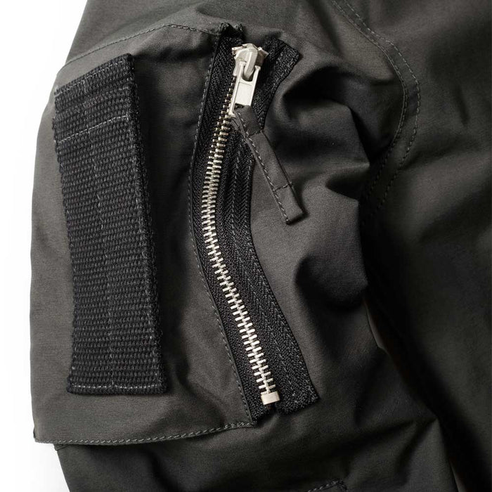 Close-up of the Men’s NASA Flight Jacket sleeve, featuring a silver zipper and a black velcro patch detail.