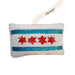 The Willis Tower Chicago Sequin Flag Ornament is shaped like a pillow and features the iconic four red stars and two blue stripes of the Chicago flag. Perfect for holiday decor, this ornament includes a ribbon labeled “Chicago” for an extra festive touch.