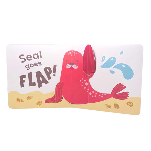 A page from "Mini Pops: In the Sea!" shows a smiling pink seal flapping its fin, with water splashes, seashells on sandy background, and bright text: “Seal goes FLAP!”—perfect for this mini pop-up board book.
