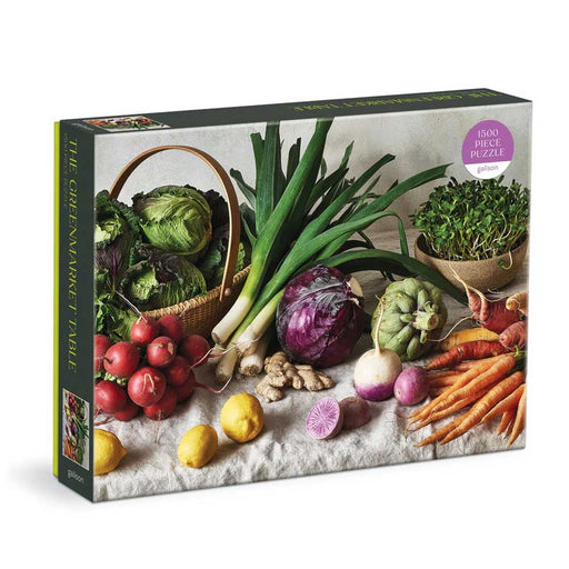 The Greenmarket Table 1500 Piece Puzzle features a vibrant array of fresh vegetables and fruits on a table, including lettuce, carrots, radishes, lemons, leeks, artichokes, sprouts, and purple cabbage.