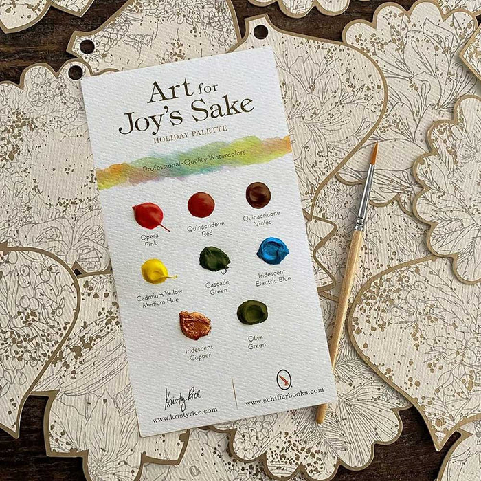 Paint your own Holiday Decorations watercolor palette card for DIY crafts, featuring eight labeled paint dots, a small brush, and several gold-outlined paper ornaments.