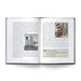 In “Chicago Cocktails: An Elegant Collection of Over 100 Recipes Inspired by the Windy City (City Cocktails),” an open book reveals two pages featuring engaging text about Chicago, complemented by a photograph of a historic building on the left page and an archival image of a freight yard with an informative caption on the right. Interwoven throughout are fascinating profiles of celebrated bartenders and timeless Chicago cocktails, inviting readers to explore both the city’s vibrant cocktail culture and