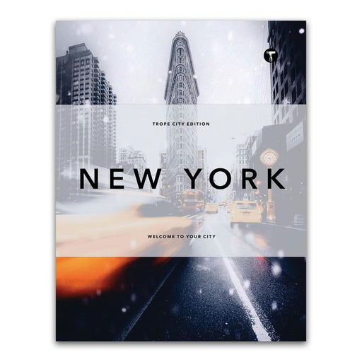 Cover of the book Trope New York (Trope City Editions, 5) features the iconic Flatiron Building surrounded by snowy city streets, blurred car lights, and soaring skyscrapers—an evocative homage to urban life. The text reads Trope City Edition and Welcome to your city, inviting readers to explore a remarkable architecture book showcasing exceptional New York photography.