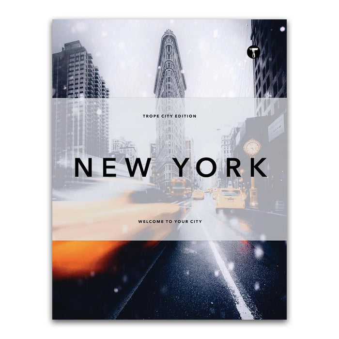 Cover of the book Trope New York (Trope City Editions, 5) features the iconic Flatiron Building surrounded by snowy city streets, blurred car lights, and soaring skyscrapers—an evocative homage to urban life. The text reads Trope City Edition and Welcome to your city, inviting readers to explore a remarkable architecture book showcasing exceptional New York photography.