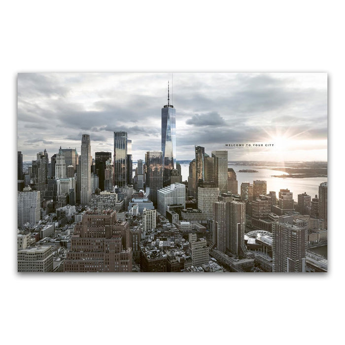 Aerial view of a modern New York city skyline with many skyscrapers under a cloudy sky, sunlight reflecting off the tallest building. Perfect for fans of urban landscapes and New York photography, as featured in Trope New York (Trope City Editions, 5). Text reads: WELCOME TO YOUR CITY.