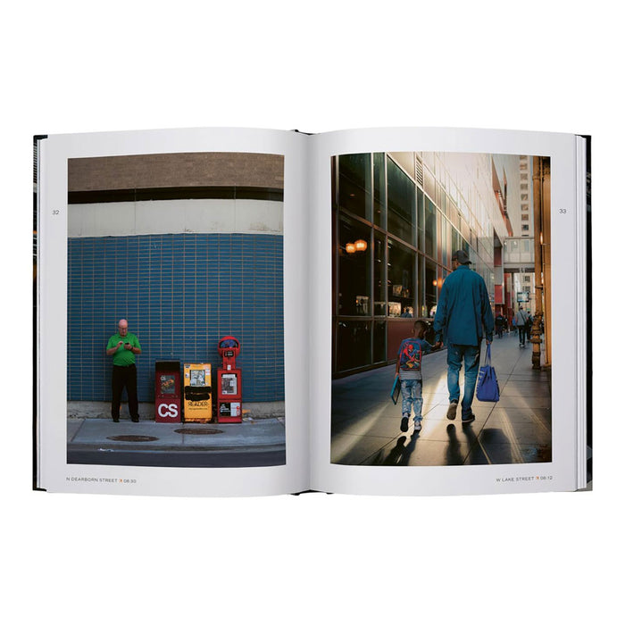 An open book, *Chicago in Transit*, displays two photos capturing Chicago photography: one of a man in a green shirt by newspaper boxes on a city street, and another of an adult and child holding hands as they walk down a bustling sidewalk—poignant reflections of urban life.