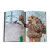 An open page of the Save The Humans – Catalogue displays an illustration of a large Thomas Dambo troll made of recycled materials, holding a birdhouse with smaller colorful ones hanging from its arms amid a landscape of birds and power lines.