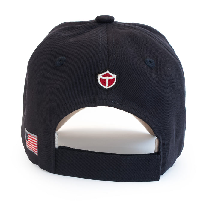 Black USS Midway Museum USST Cap featuring an embroidered shield logo on the back and a small American flag patch on the side.