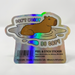 Brevard Zoo Capybara Holographic Sticker featuring a capybara sitting in a pond with the text DONT WORRY BE CAPY above and below the animal.