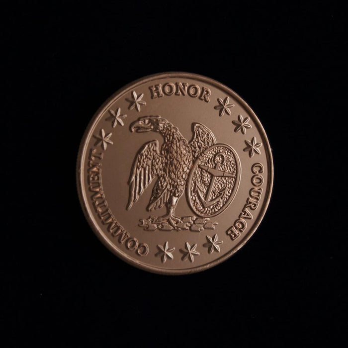 The USS Constitution Limited Edition Collector's Medallion is a bronze coin featuring an eagle, shield, and stars with HONOR, COURAGE, and COMMITMENT inscribed along the edge—a standout Navy collectible on a sleek black background.
