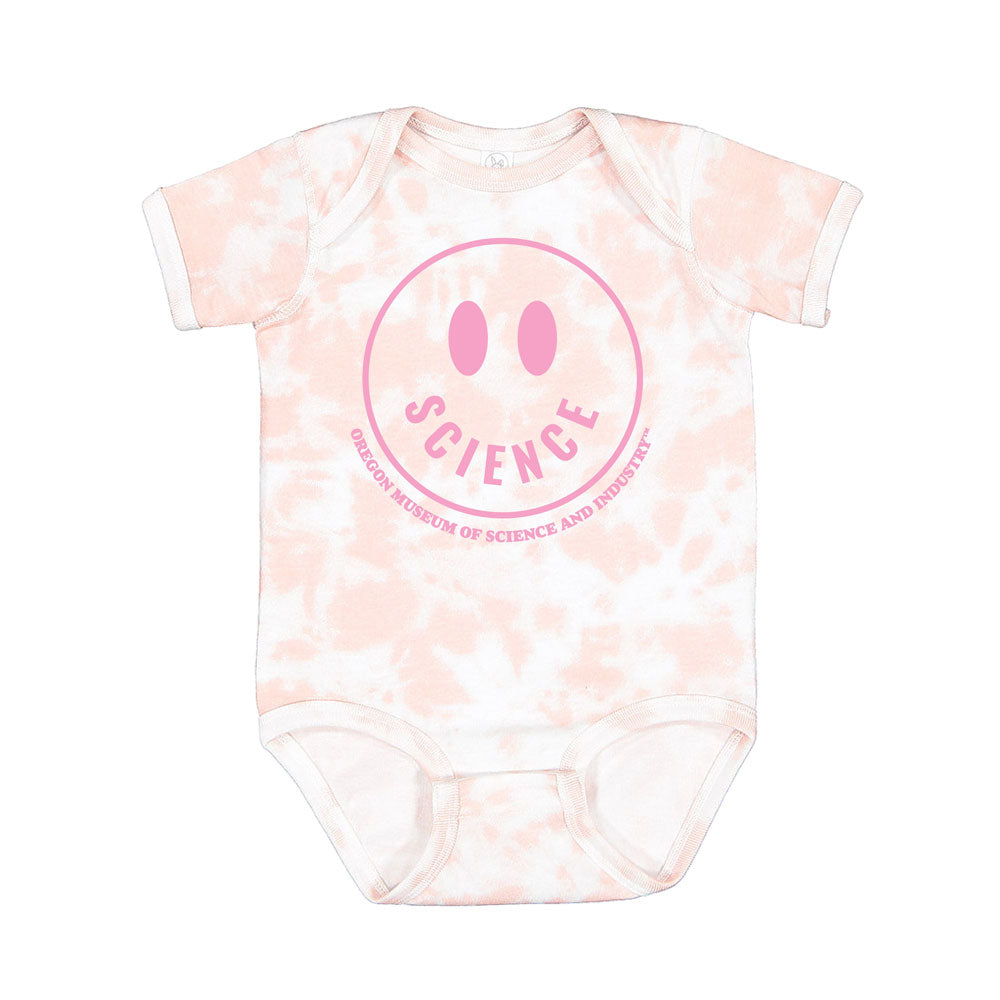 The Oregon Museum of Science and Industry Smiley Tie-Dye Infant Onesie is a pink and white onesie with a playful smiley face and "SCIENCE" surrounded by "Oregon Museum of Science and Industry" in a circle.