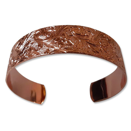 The USSCM Reclaimed Copper Bracelet is hand-crafted in the USA with an engraved floral and vine pattern, open back, and a polished finish.